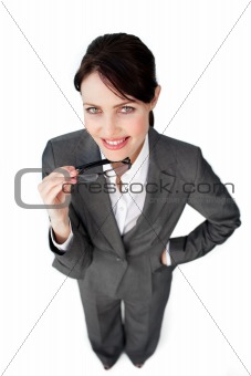 Self-assured businesswoman holding glasses 