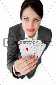 Charming businesswoman holding a full deck aces 