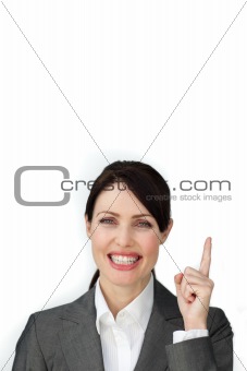 Radiant businesswoman pointing at a copyspace 