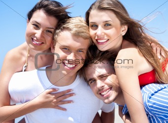 Two Young man giving piggyback to their girlfriends