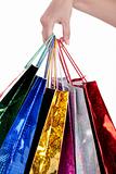 Colorful shopping bags holding by human hand