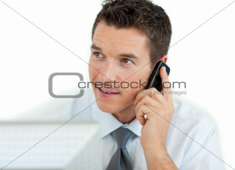 Businessman on phone working at a computer