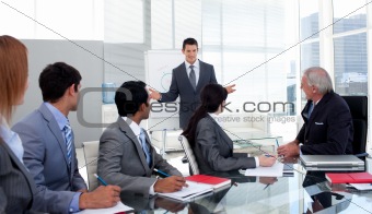 Confident businessman giving a presentation to his team