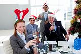 Multi-ethnic busioness team toasting with Champagne at a Christm