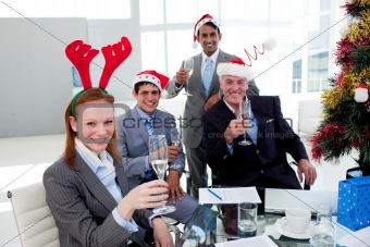 Multi-ethnic busioness team toasting with Champagne at a Christm