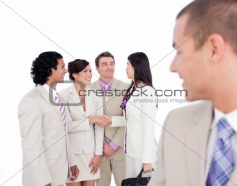 Positive business co-workers shaking hands 