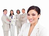 Portrait of latin businesswoman smiling with his team