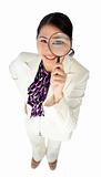 Confident businesswoman holding a magnifying glass 