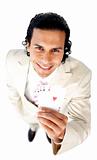 Charming businessman showing a successful hand of cards 