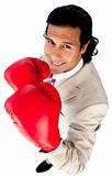 Competitive businessman wearing boxing gloves 