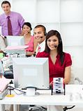 Smiling business people with headset on working 