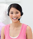 Charming young businesswoman talking on headset 