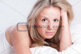 Portrait of young woman in bed