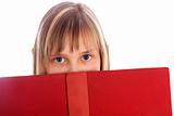 young girl looks out on a red book 