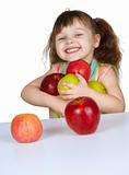 Happy little girl with apples