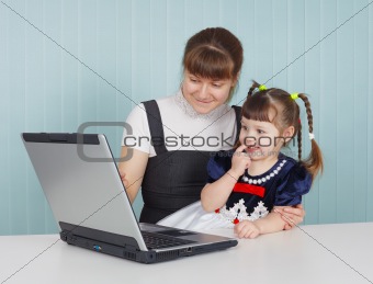 Mother and child playing with laptop
