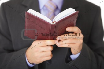 Man reads entries in notebook - close-up