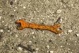 Old rusty wrench on ground