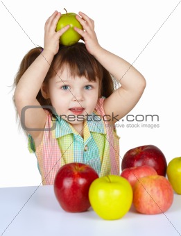 Little girl plays with fruit - apples