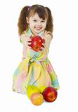 Happily smiling little girl gives an apple