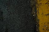 Black tarmac and yellow road marking