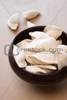 Delicious ravioli in a clay pot