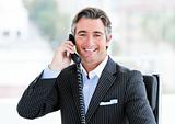 Self-assured mature businessman talking on phone 