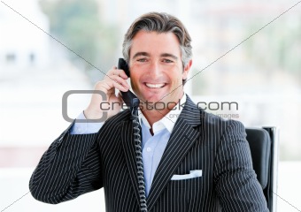 Self-assured mature businessman talking on phone 