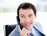 Assertive young businessman talking on phone 