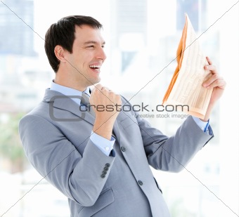 Happy businessman reading a newspaper