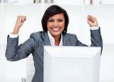 Confident businesswoman punching the air in celebration