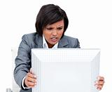 Frustrated businesswoman shaking her computer's screen