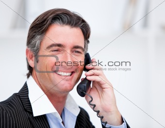 Handsome mature businessman talking on phone