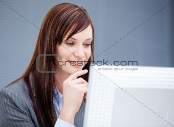 Radiant businesswoman working at a computer 