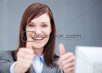 Jolly businesswoman with thumbs up 