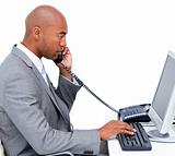 Serious Afro-American businessman talking on phone