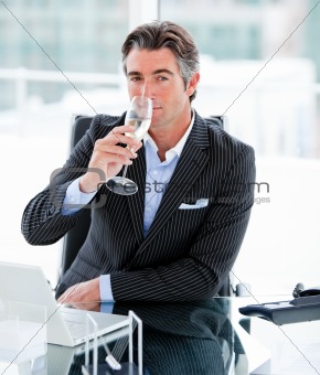 Confident businessman drinking a glass of water