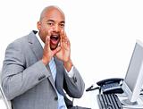 Afro-american businessman yelling sitting at his desk