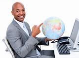 Smiling businessman holding a terrestrial globe