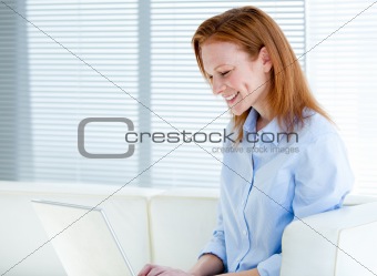Happy business woman working on a laptop computer 