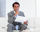 Smiling businessman holding a note
