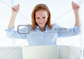 Radiant business woman punching the air