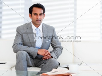 Self-assured businessman sitting on the sofa