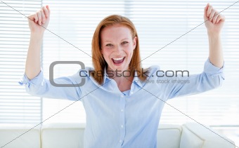 Nice business woman punching the air