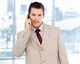 Assertive businessman talking on phone standing 
