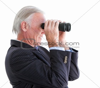 Senior businessman looking through binoculars standing 