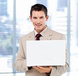 Handsome businessman using a laptop standing