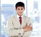 Self-assured businessman with folded arms standing 
