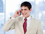 Laghing businessman talking on phone standing 