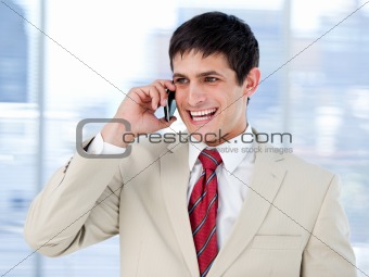 Laghing businessman talking on phone standing 
